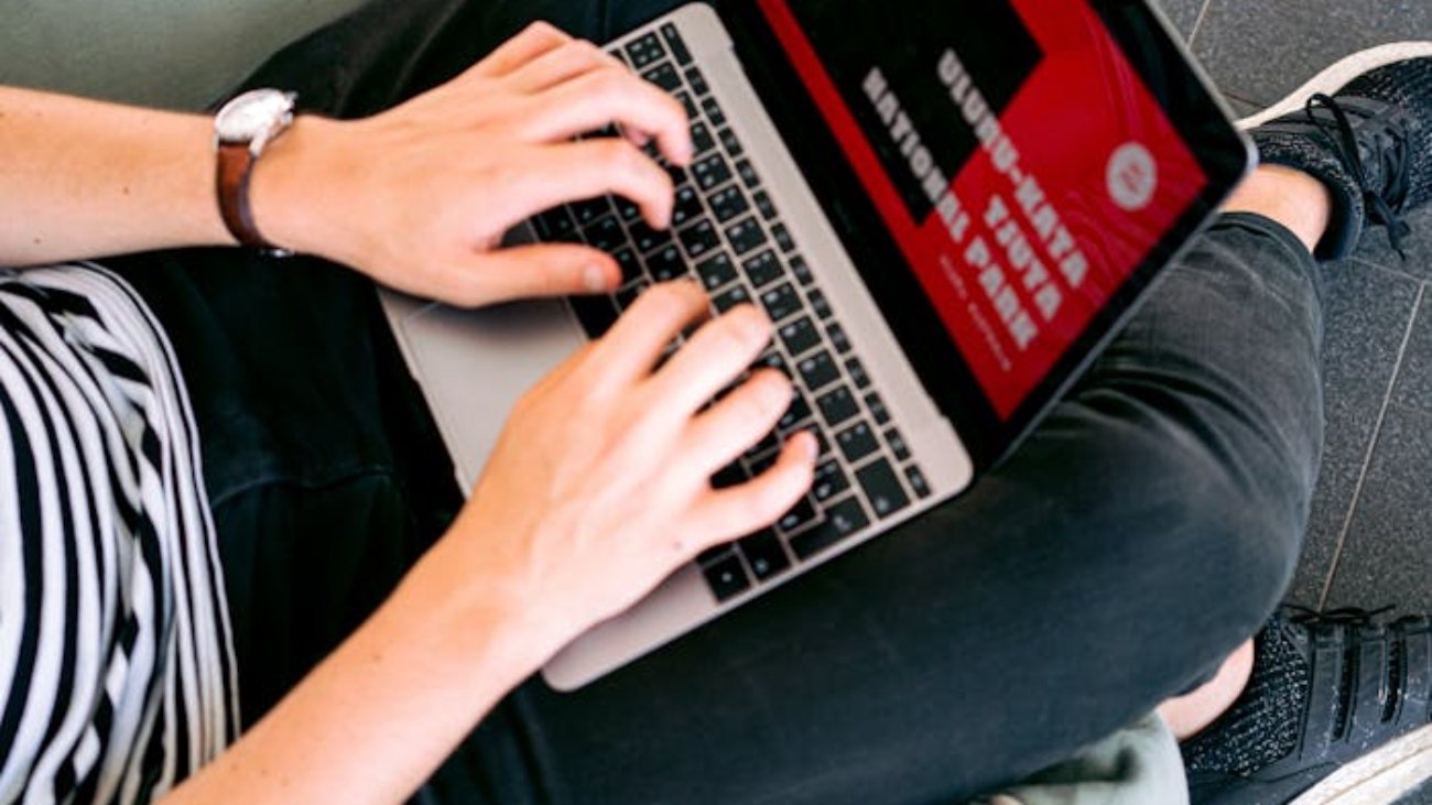 Man Creating a Presentation on Laptop